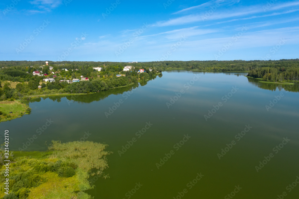 Top view of the forest lake and vegetation along its shores