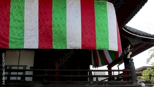 Shinran Shonin Japanese Temple Architecture . Green, White, Red flag photo