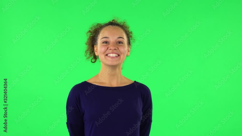 Portrait of curly woman sbursting with laughter being in positive. Green screen Portrait of curly woman sbursting with laughter being in positive. Green screen