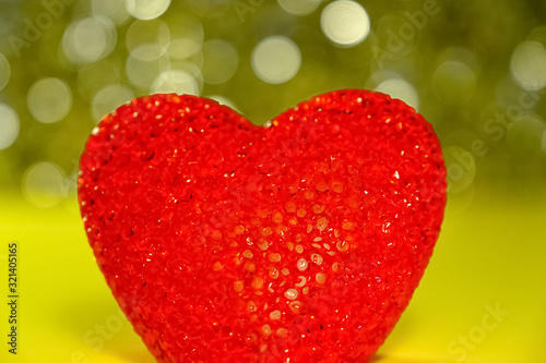 Red heart shape on a yellow shiny background. Concept of love emotions