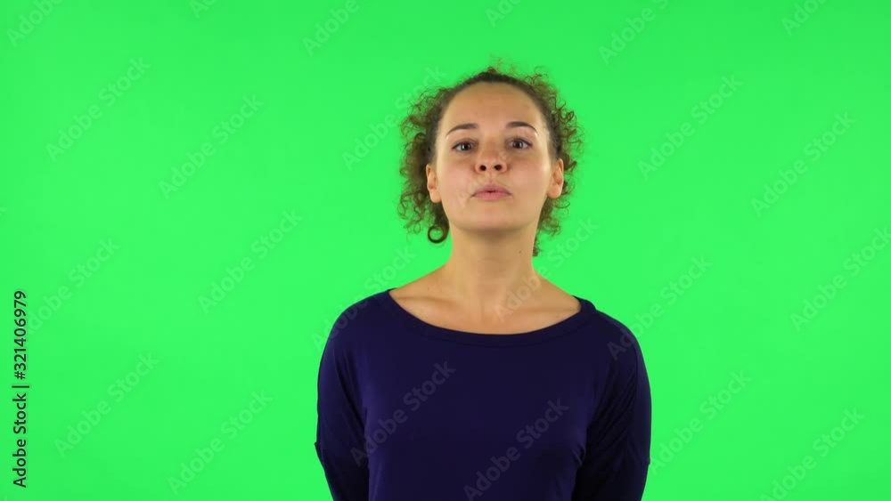 Portrait of curly woman standing in front of the camera, saying oh my god and being shocked. Green screen Portrait of curly woman standing in front of the camera, saying oh my god and being shocked. Green screen