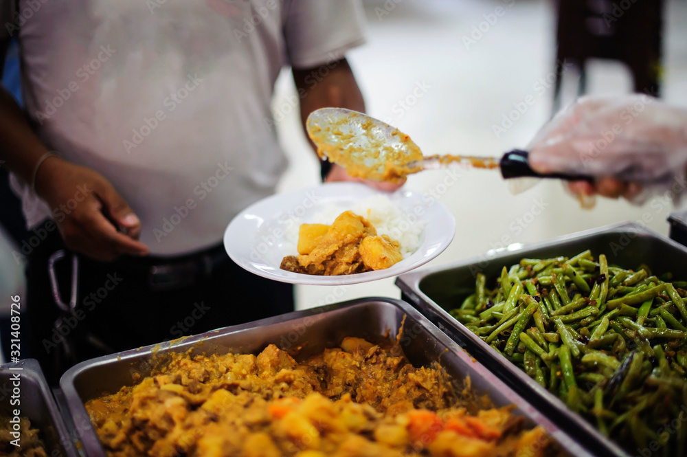 Feeding the poor to hands of a beggar, Poverty concept Feeding the poor to hands of a beggar, Poverty concept