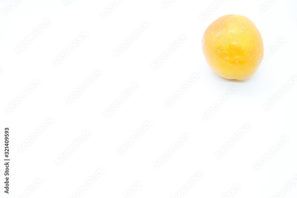 Ripe orange plums perched on a white background Ripe orange plums perched on a white background