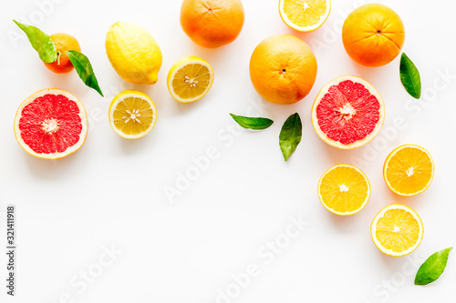 Fresh citrus frame. Oranges  tangerines  grapefruits  leaves on white background top-down copy space