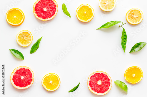Citrus fruits - lemons, grapefruit slices - on white background mockup, frame top-down copy space