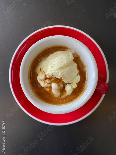 Wallpaper Mural red cup of espresso coffee with vanila icecream on black table background. Torontodigital.ca