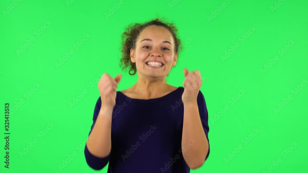 Portrait of curly woman looking at the camera with excitement, then celebrating her victory triumph . Green screen Portrait of curly woman looking at the camera with excitement, then celebrating her victory triumph . Green screen