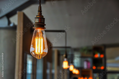 Vintage light bulb in modern restaurant close up.