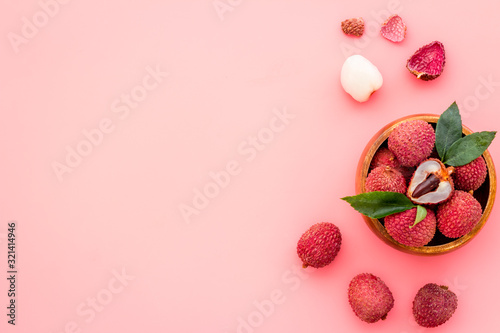 Photography Fresh ripe lychee in bowl on pink desk top-down frame copy space