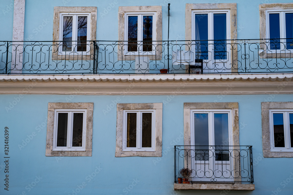 Pretty pale blue building facade, typical of Alfama neighborhood in Lisbon, Portugal