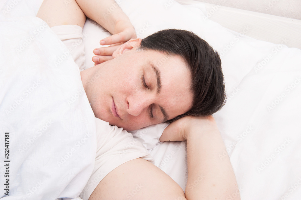 Brunette man sleeping in bed Brunette man sleeping in bed