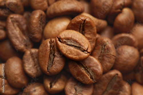 Roasted coffee beans close up. Espresso dark  aroma  black caffeine drink