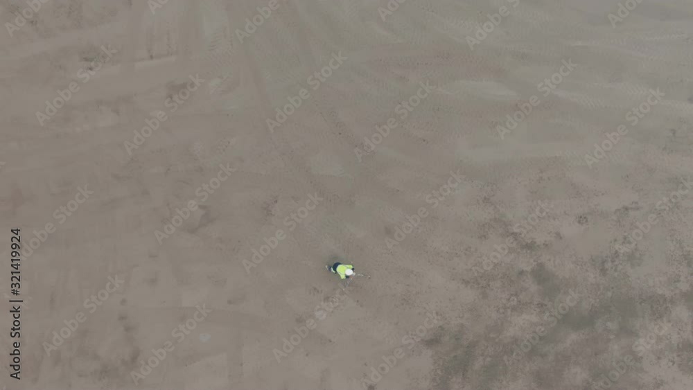 Aerial view of construction engineer doing landscape work using leveling unit Aerial view of construction engineer doing landscape work using leveling unit