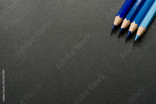 Blue colored pencils on a black background