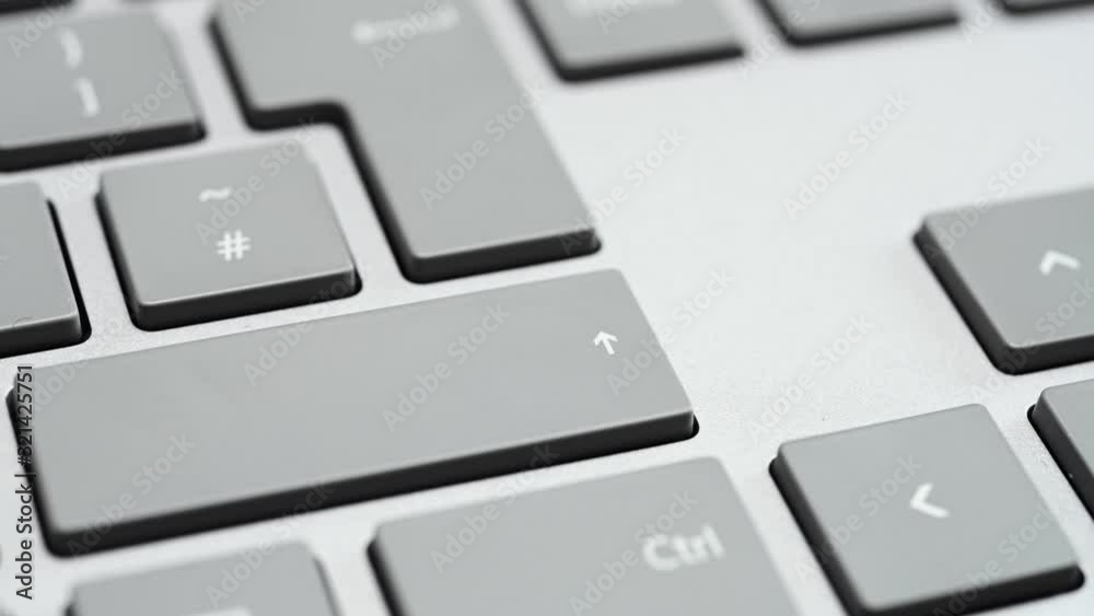 Finger pressing the shift key close up shot Finger pressing the shift key close up shot