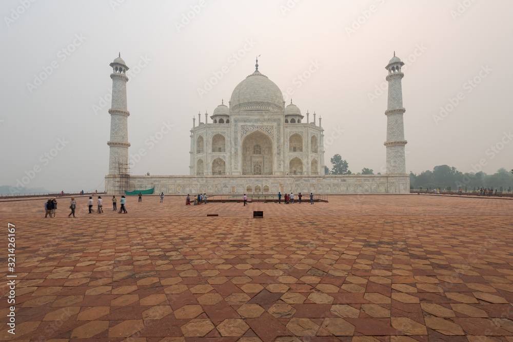 Left side of the Taj Mahal in Agra, India, on overcast morning with smog
