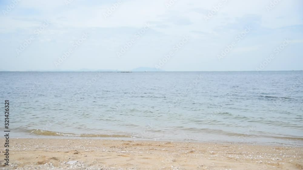 Tropical beach with white sand and blue sea in summer time on sunny day. Sea peaceful beach scenery foamy wave on the beach with waves of blue sea tropical ocean sand. travel vacation seaside. Tropical beach with white sand and blue sea in summer time on sunny day. Sea peaceful beach scenery foamy wave on the beach with waves of blue sea tropical ocean sand. travel vacation seaside.