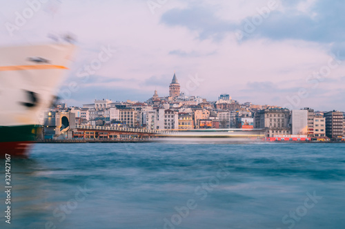 Istanbul, Turkey - Jan 15, 2020: Galata Tower with Ferry Boat in Golden Horn , Istanbul, Turkey,