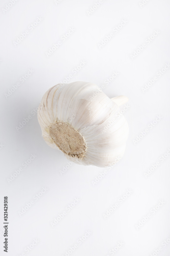 Unpeeled garlic isolated on white background, fresh vegetable rich in vitamins, garlic have beneficial properties for colds treatment, the smell of garlic can be sensed in almost every dish Unpeeled garlic isolated on white background, fresh vegetable rich in vitamins, garlic have beneficial properties for colds treatment, the smell of garlic can be sensed in almost every dish