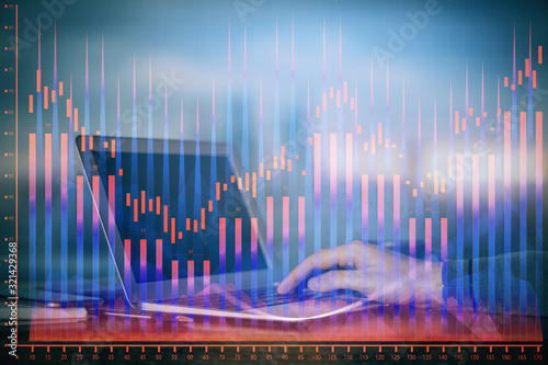 Double exposure of stock market graph with man working on laptop on background. Concept of financial analysis. © peshkova