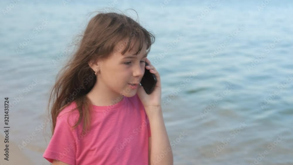 The girl talking on the phone on the beach. The girl talking on the phone on the beach.