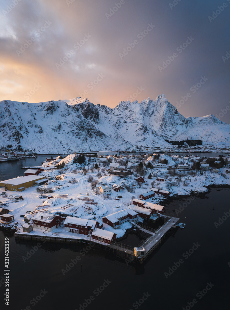 Aerial photography of Ballstad town in lofoten islands in north of norway from drone. Winter Vestvågøy island during sunset. Famous Hattvika lodge.