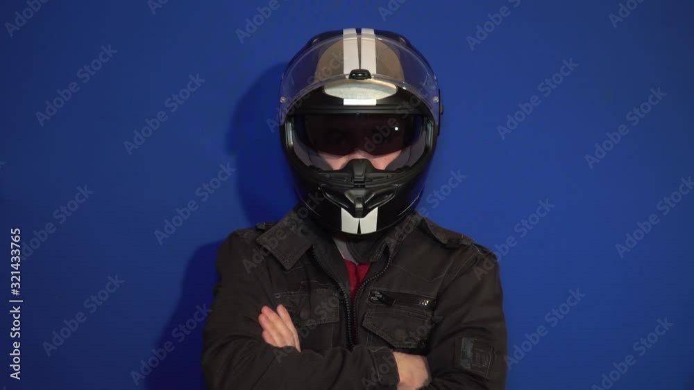 Male biker in a helmet nods at the camera Male biker in a helmet nods at the camera