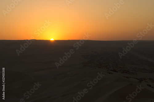Sunset in Huacachina desert  Peru