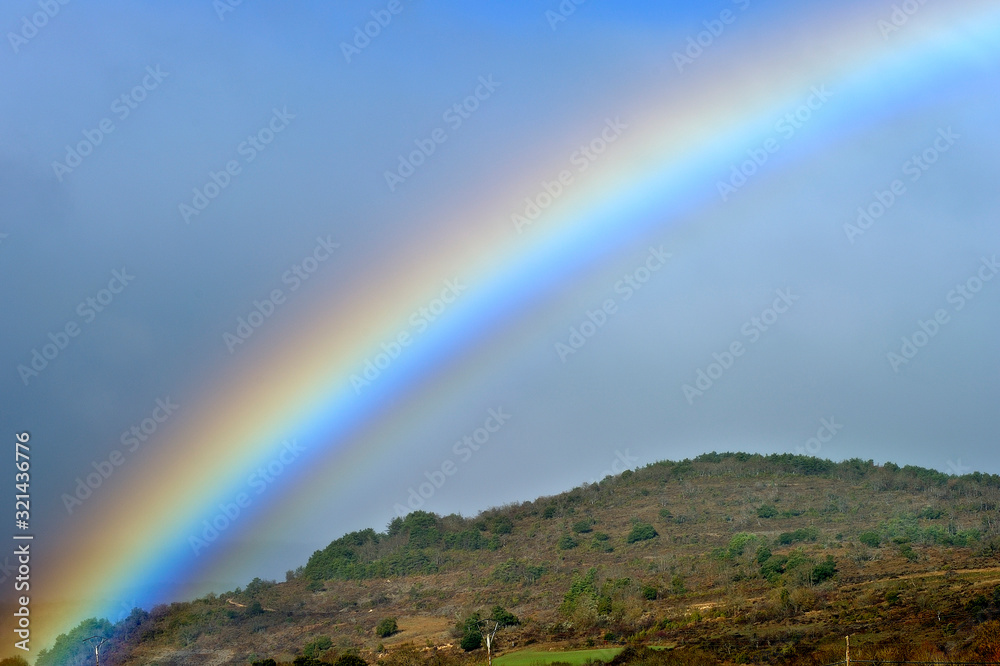 Bright rainbow over the mountain Bright rainbow over the mountain