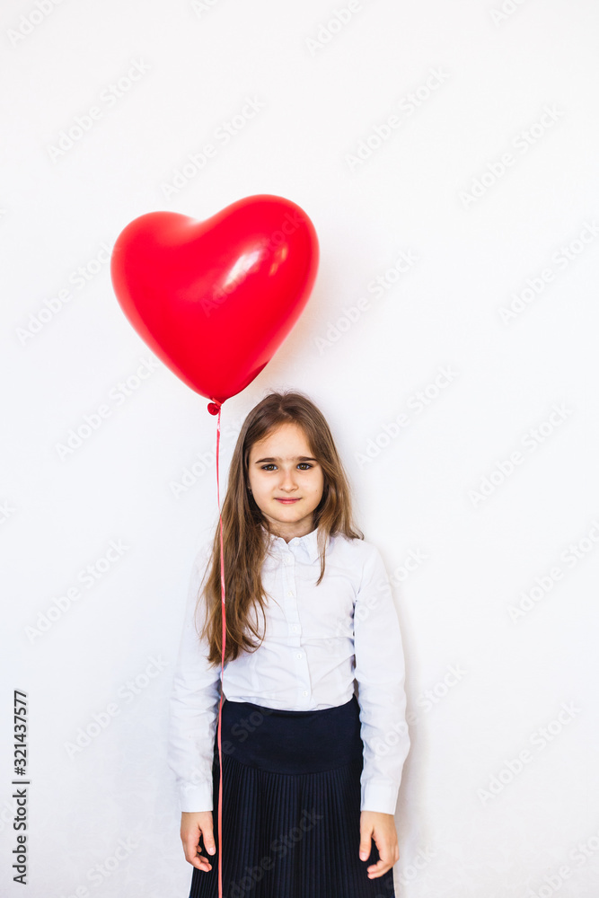 European-looking girl on a white background holding a heart-shaped balloon, balloon, heart, love, Valentine's day, birthday, holiday European-looking girl on a white background holding a heart-shaped balloon, balloon, heart, love, Valentine's day, birthday, holiday