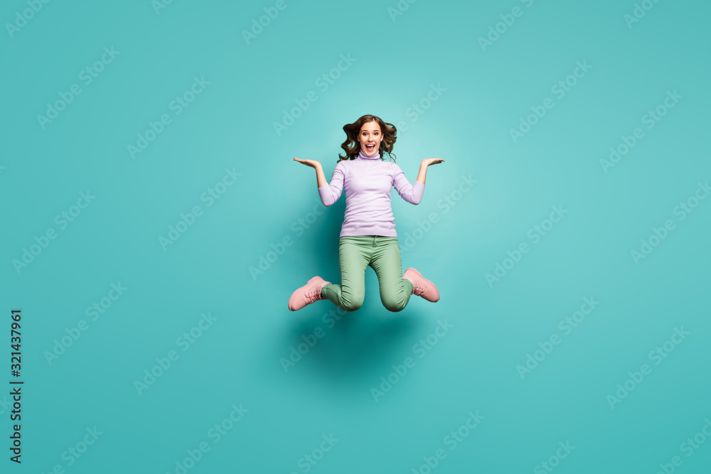 Full length photo of crazy lady jump high hold open arms with sale products proposing low shopping prices wear purple jumper green pants footwear isolated teal pastel color background