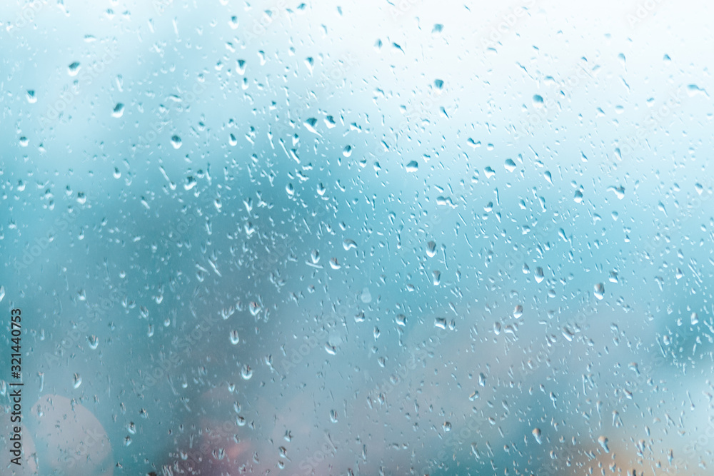 Raindrops on the window, the background is blurred. Gray color. Copy space