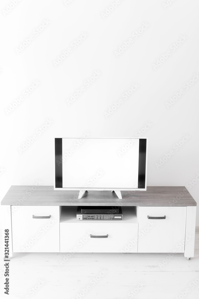 TV with white screen on a stand in the room. TV with white screen on a stand in the room.