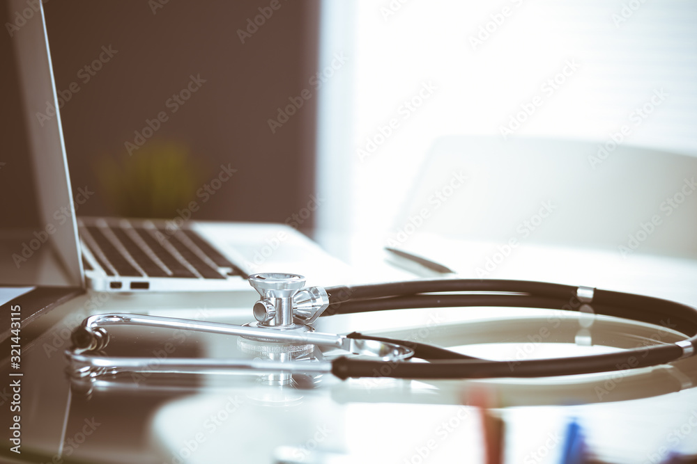 Stethoscope, prescription medical form lying on glass table with laptop computer. Medicine or pharmacy concept. Medical tools at doctor working table Stethoscope, prescription medical form lying on glass table with laptop computer. Medicine or pharmacy concept. Medical tools at doctor working table