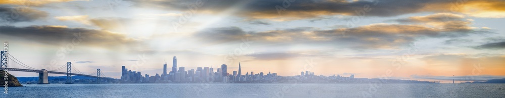 Sunset panoramic view of San Francisco. City skyline over the water