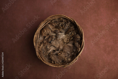 Newborn photography digital background prop. wicker basket with brown fur on a painted canvas.