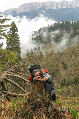Girl with a backpack rises above the clouds