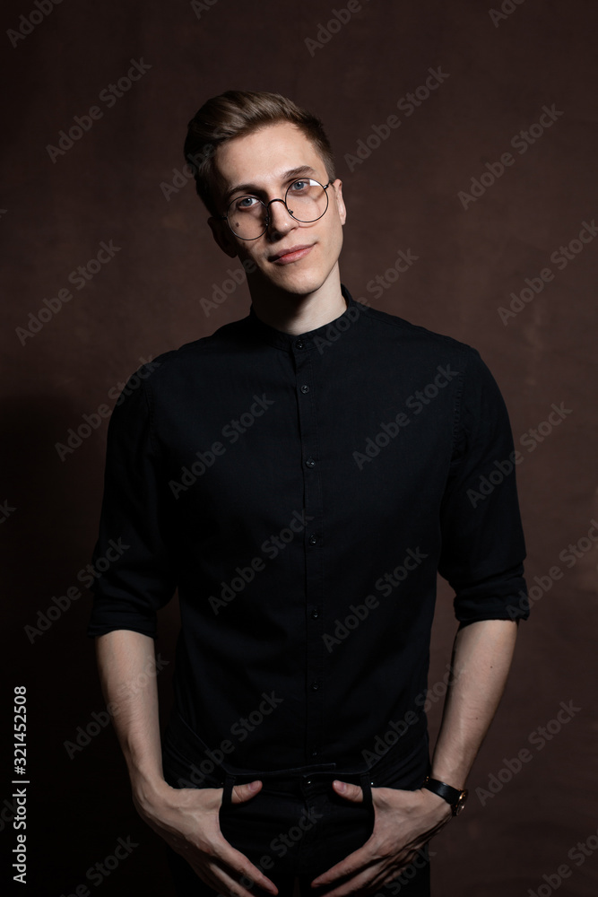 Man in round glasses and a black shirt. Man in round glasses and a black shirt.