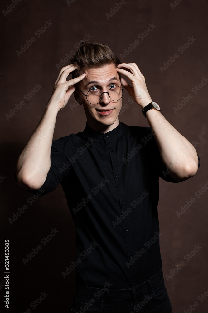 Man in round glasses and a black shirt.