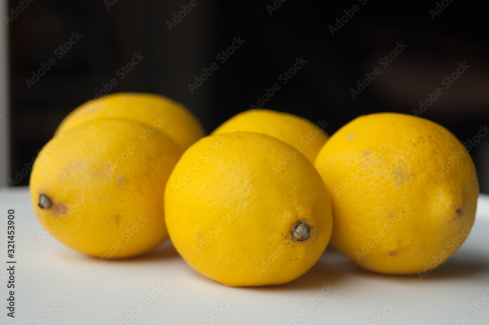 lemons on white table and black background