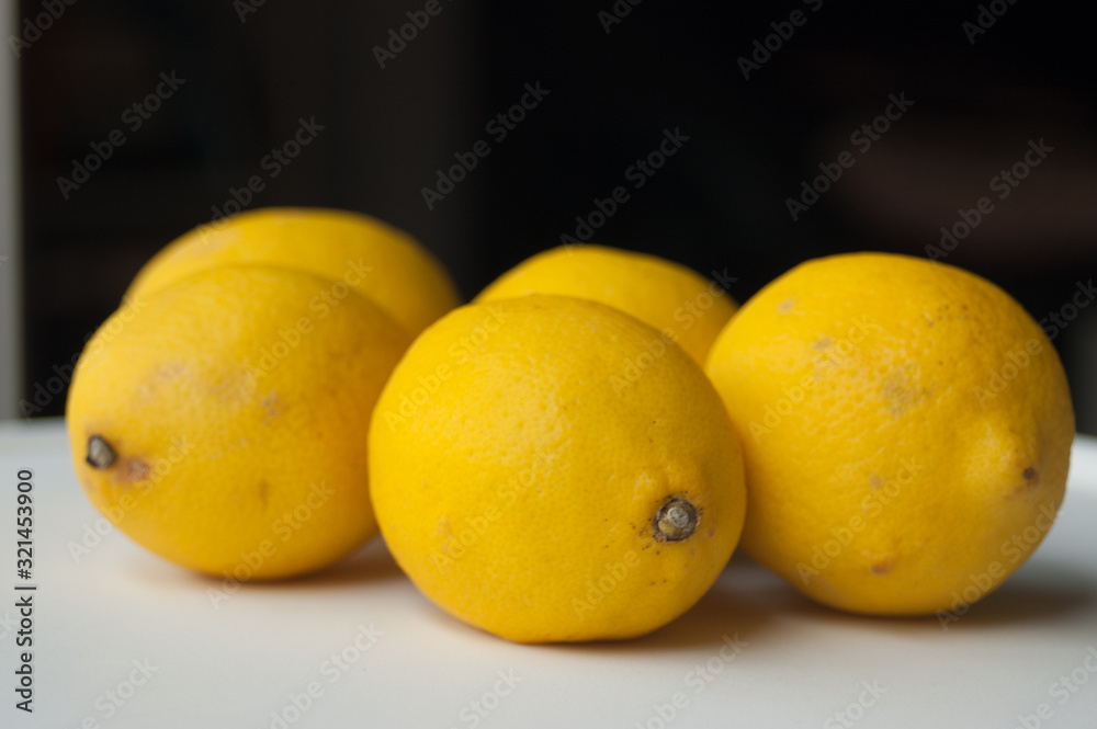 lemons on white table and black background lemons on white table and black background