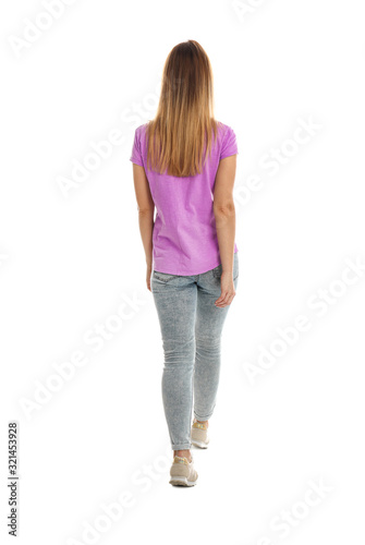 Young woman posing on white background, back view