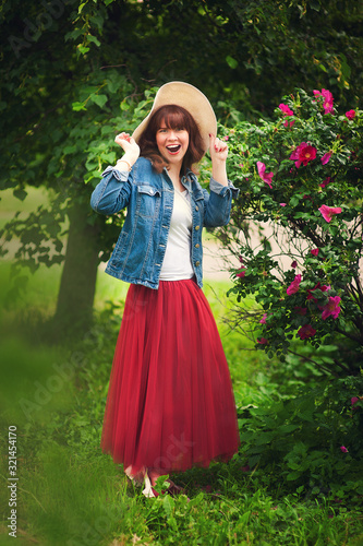 Backlight portrait of a happy girl. Sunset in the park with warm yellow light and a rustic background