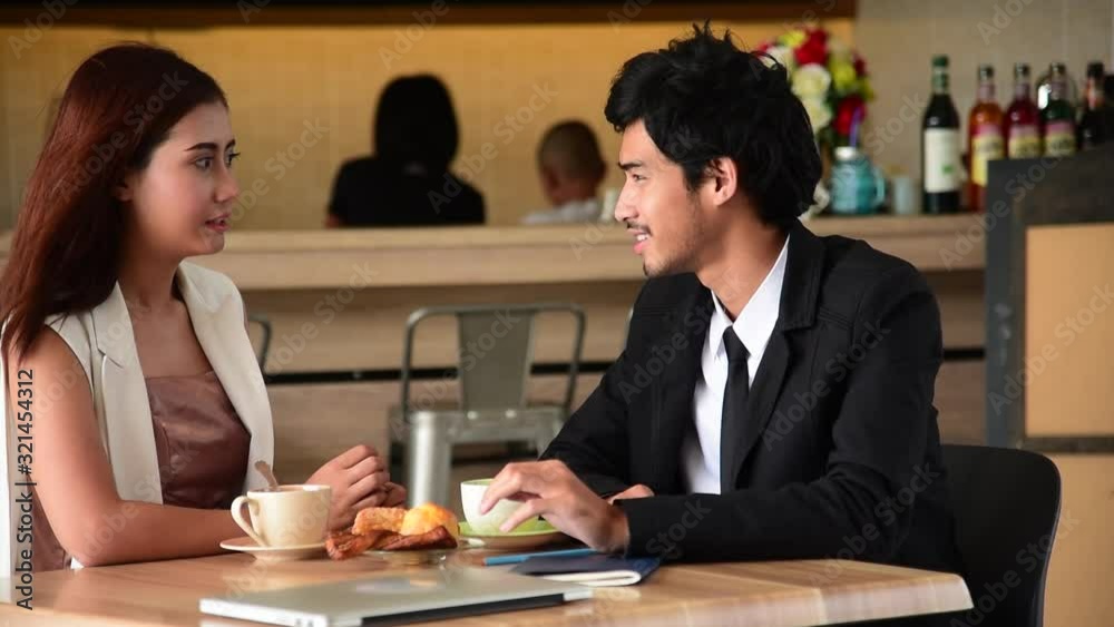 Young couple talking in cafe coffee shop happy date couple communication positive relationship while relaxing in cafe drinking coffee and talkative. Valentine's day concept. Young couple talking in cafe coffee shop happy date couple communication positive relationship while relaxing in cafe drinking coffee and talkative. Valentine's day concept.