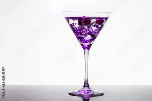 Long exposure martini glass with ice and olives