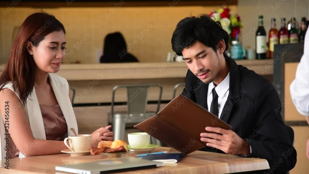Customer use credit card payment for food at restaurant. Young couple checkout bill and pay via credit to cashier nfc contactless machine. Customer use credit card payment for food at restaurant. Young couple checkout bill and pay via credit to cashier nfc contactless machine.