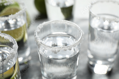 Mexican Tequila shots with salt on table, closeup