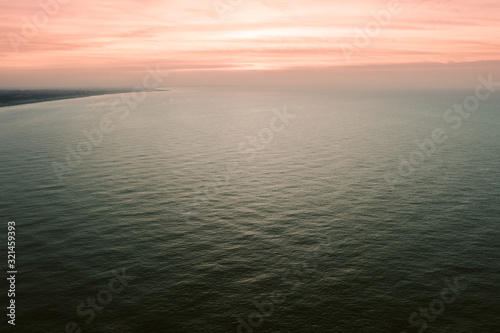 Small ocean waves at the sunset
