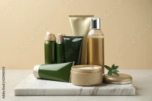 Obraz Different cosmetic products on white table against beige background
