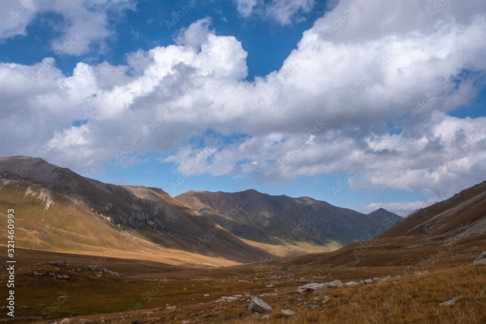 Beautiful mountains nature landscape with cloudy blue sky. Beauty nature background. Trekking hiking. Beautiful alpine landscape. Beautiful mountains nature landscape with cloudy blue sky. Beauty nature background. Trekking hiking. Beautiful alpine landscape.